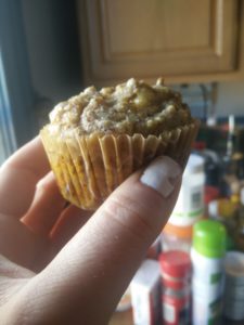 A photo of a hand holding a muffin.