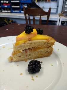 A double layer cake, featuring peaches and blackberries!
