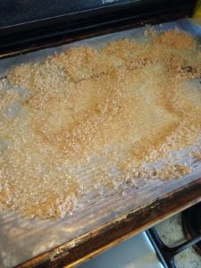 Smoked salt drying on a baking sheet.